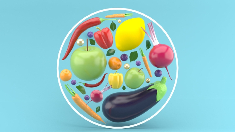 Ein veganer Kreis aus Obst und Gemüse auf blauem Hintergrund.